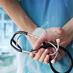doctor in scrubs holding stethoscope