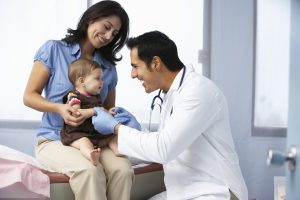 doctor helping baby checkup