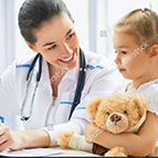 doctor smiling at child with teddy bear