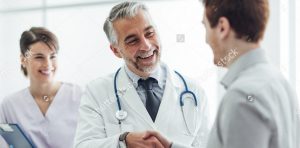 stock-photo-smiling-doctor-at-the-clinic-giving-an-handshake-to-his-patient-healthcare-and-professionalism