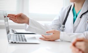 doctor pointing to computer screen
