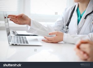 stock-photo-doctor-and-patient-are-discussing-something-just-hands-at-the-table