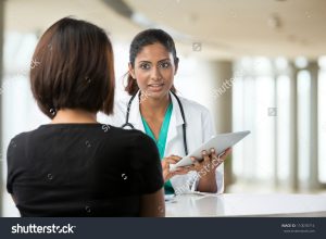 stock-photo-doctor-talking-with-female-patient-in-doctors-office