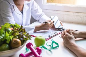 A nutritionist consults with a patient about healthy eating